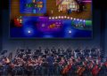 Musicians rehearsing for Stardew Valley Symphony under ConcernedApe's direction